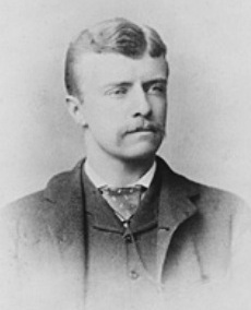 Image of Teddy Roosevelt as a Young man - dark clothes, white shirt, light hair, with mustache