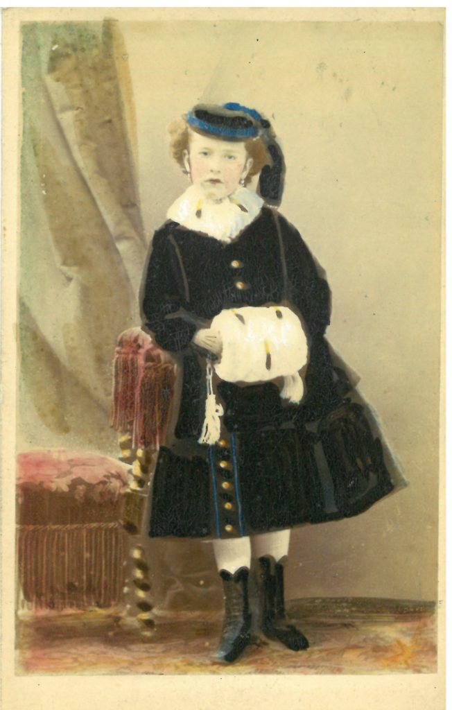 Tinted photograph of Kitty as a young child. (on the reverse is a dedication from Kitty to her Uncle Henry)