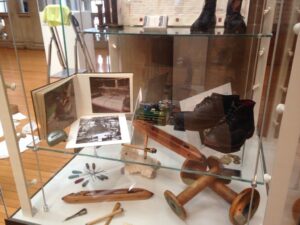 View inside exhibition with close up of old boots