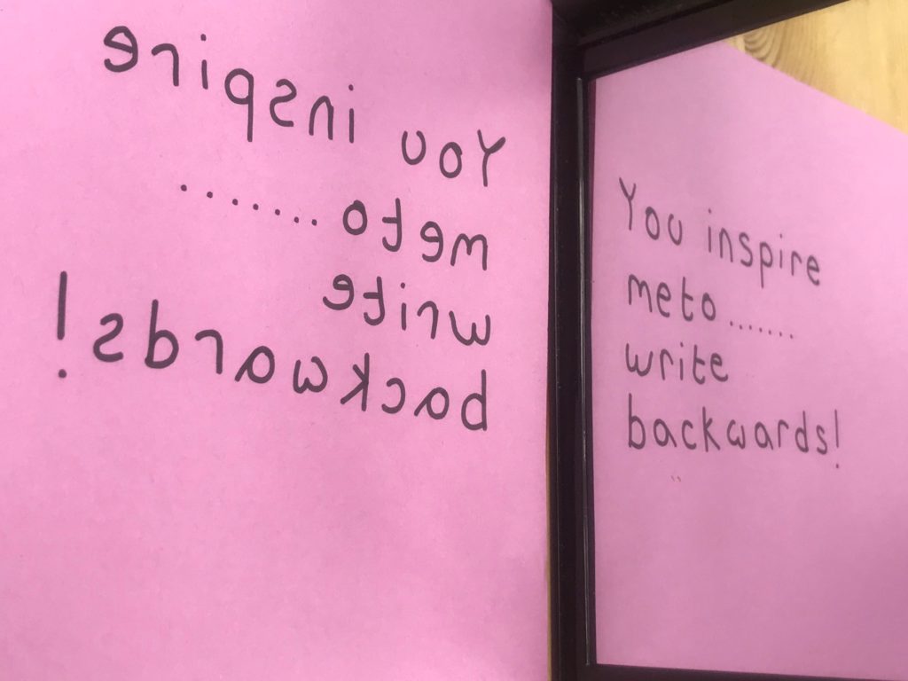 Image of text written backwards reflecting in a mirror to read 'You inspire me to...write backwards'