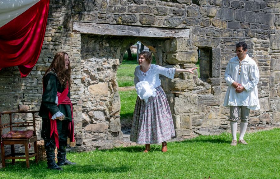 actors playing the Duke of Newcastle, and two servants acting a scene by the medieval wall