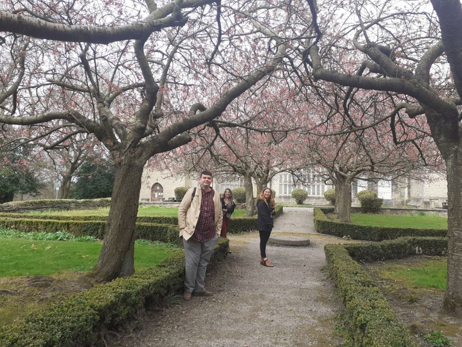 3 people in the grounds of Bolling Hall -  all are smiling