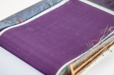Image of a purple sample of fabric (within the book)