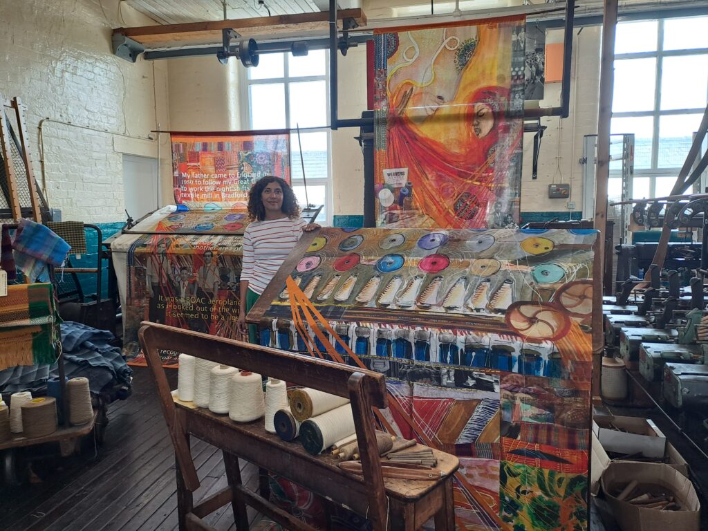 Rhian in front of the textile piece
