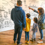 Family group looking at a mural