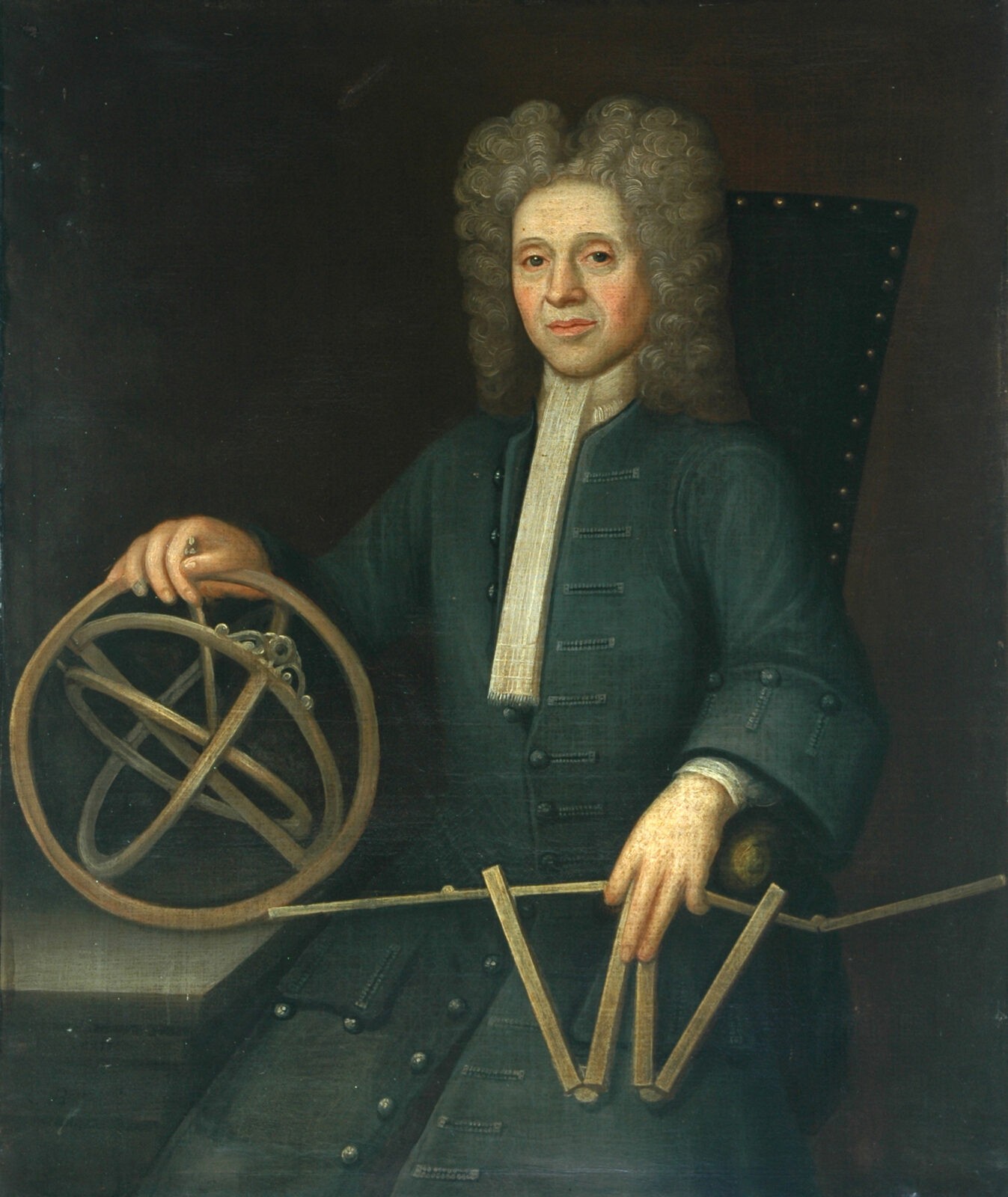 a man in georgian clothing, a long grey curly wig holding astronomical models