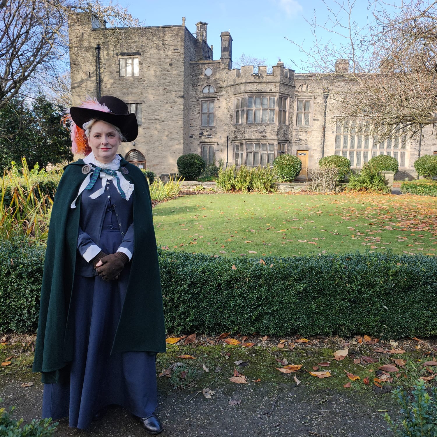 Mrs Tempest in 17th Century clothing stood outside Bolling Hall