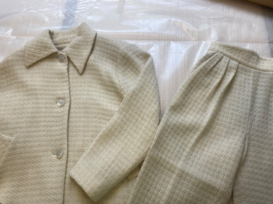 A light cream woven jacket and matching trousers - all the same colour with a pattern formed by the woven texture