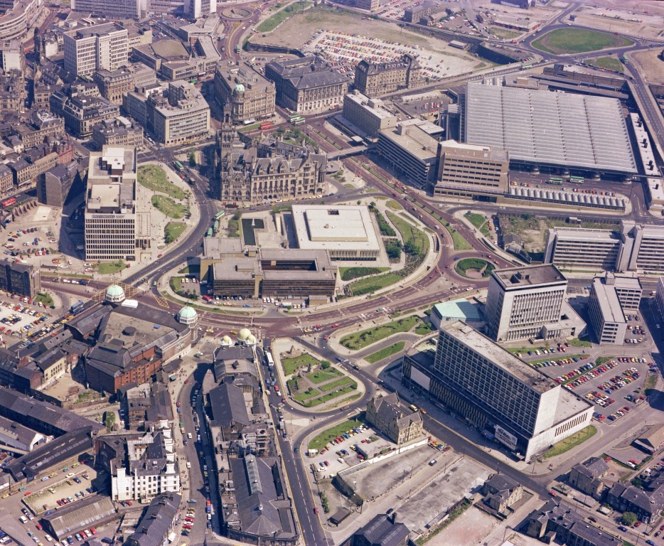 Caption: A colour aerial view of Bradford city centre taken in June 1978. Taken from almost the same angle as the other photo, Bradford City Hall is now within a ring road. Photographer: C H Wood. In Bradford District Museums and Galleries collection (23049).