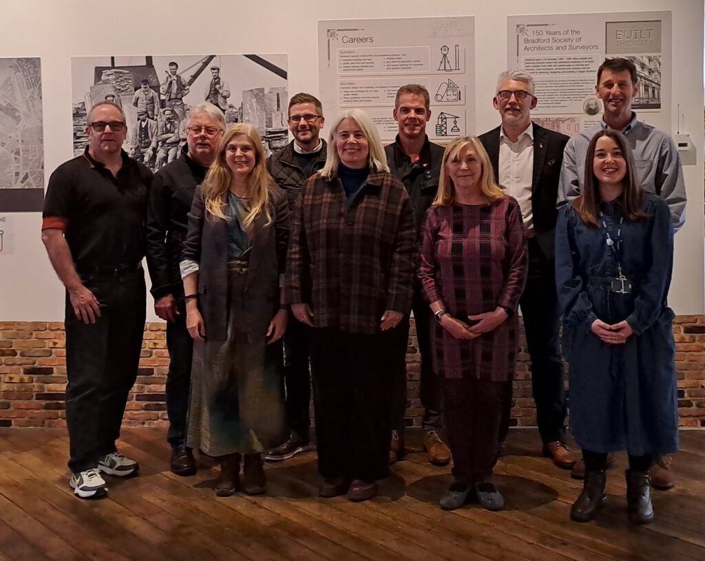 Photograph shows members of the Bradford Society of Architects and Surveyors with exhibition curator Lauren Padgett at the exhibition launch event.