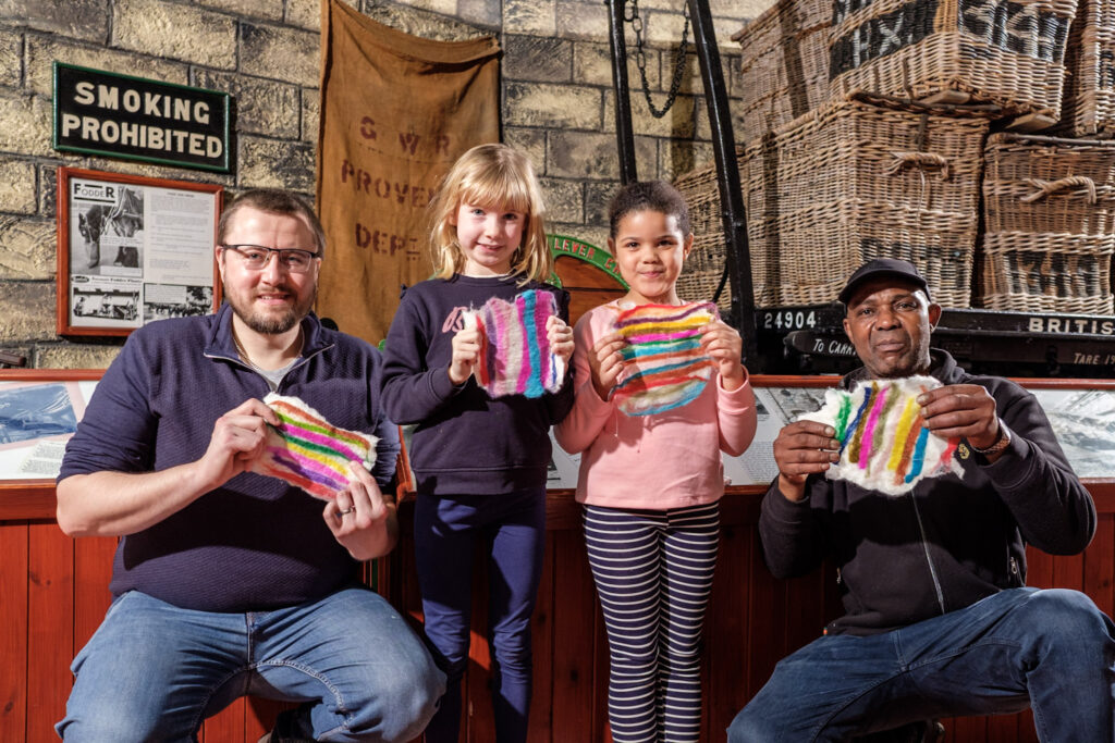 group of adults and kids showing their felted creations!