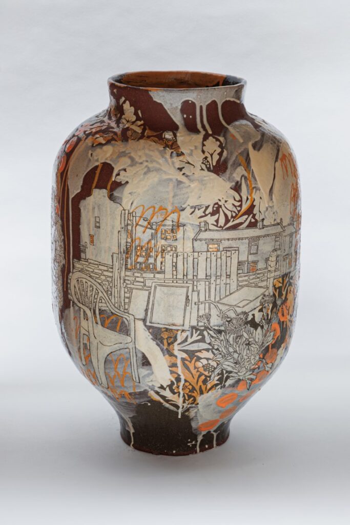 Ceramic vase with a orangy-brown base colour, decorated with images of pallets, chairs, gardening implements and allotment imagery in tones of white, cream and orange