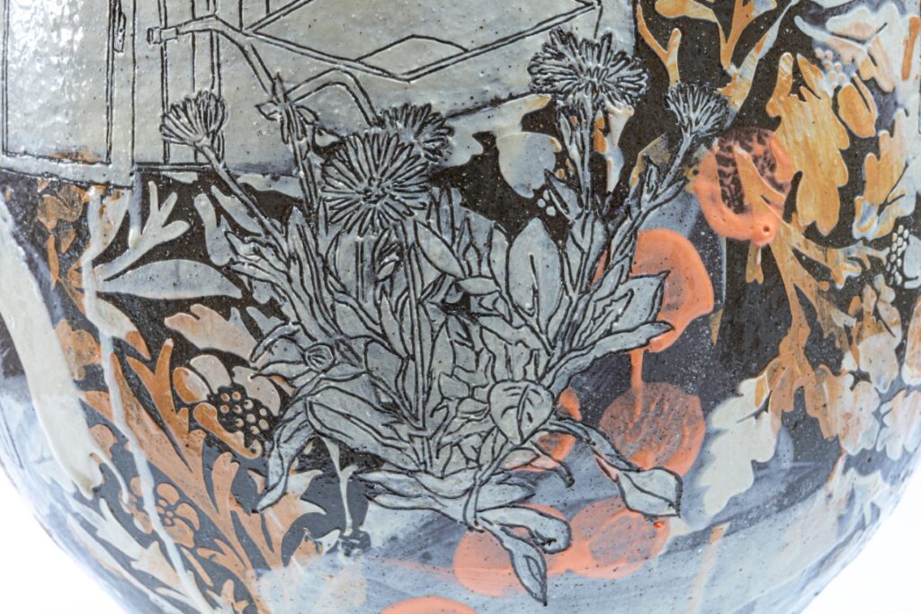 close up of details of the vase - this one is focused mostly on flowers and plant imagery