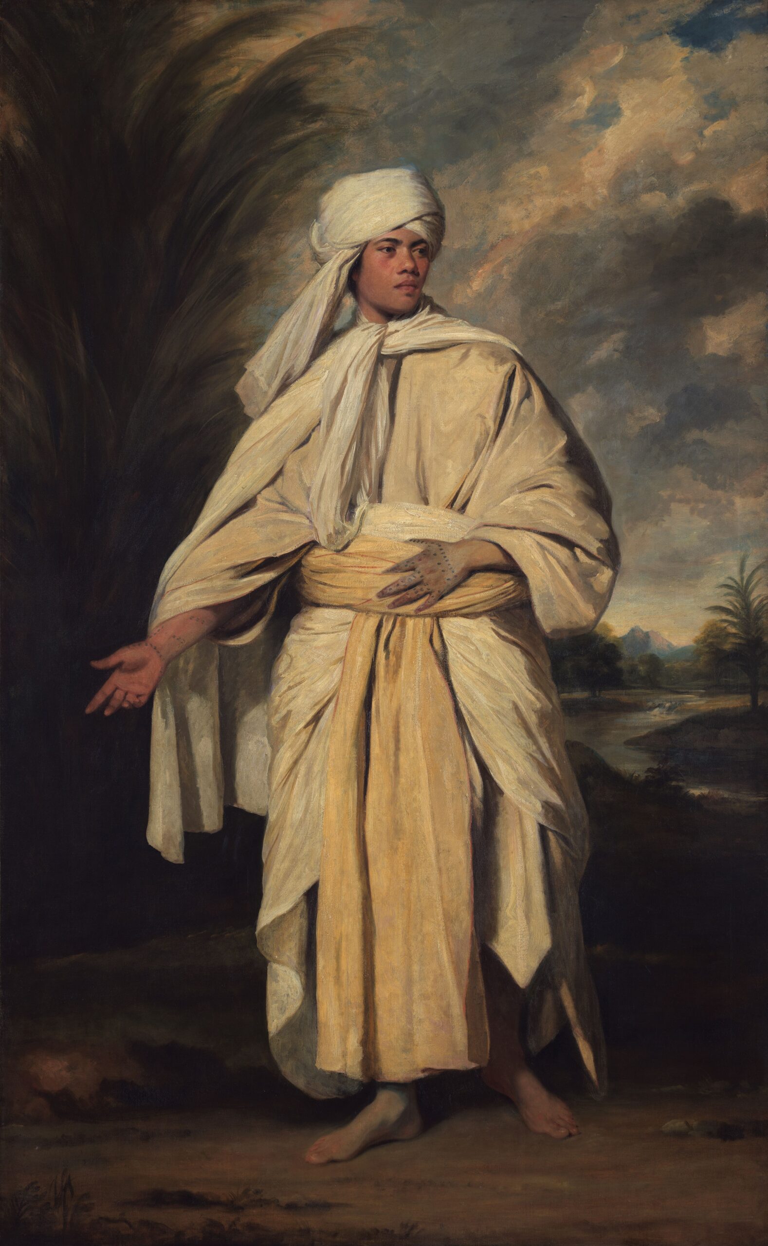 painting of a young man of colour, dressed in a version of ceremonial Tahitian dress. He is barefoot and stood in a rural landscape.