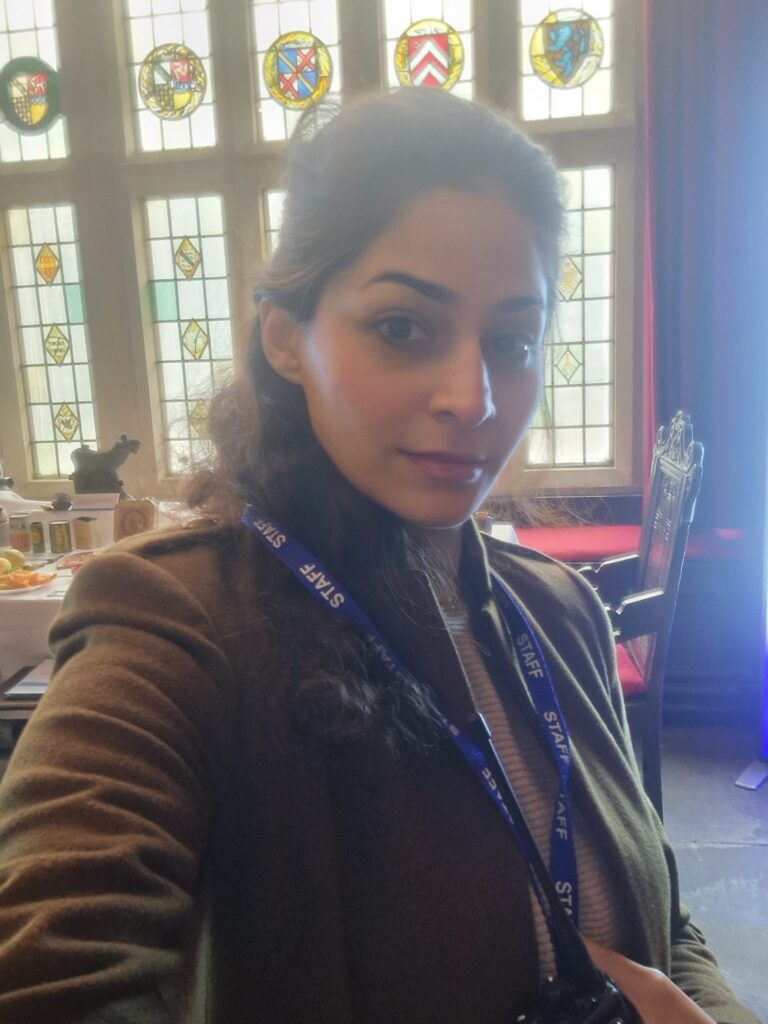 Fatima in front of stained glass windows inside the hall