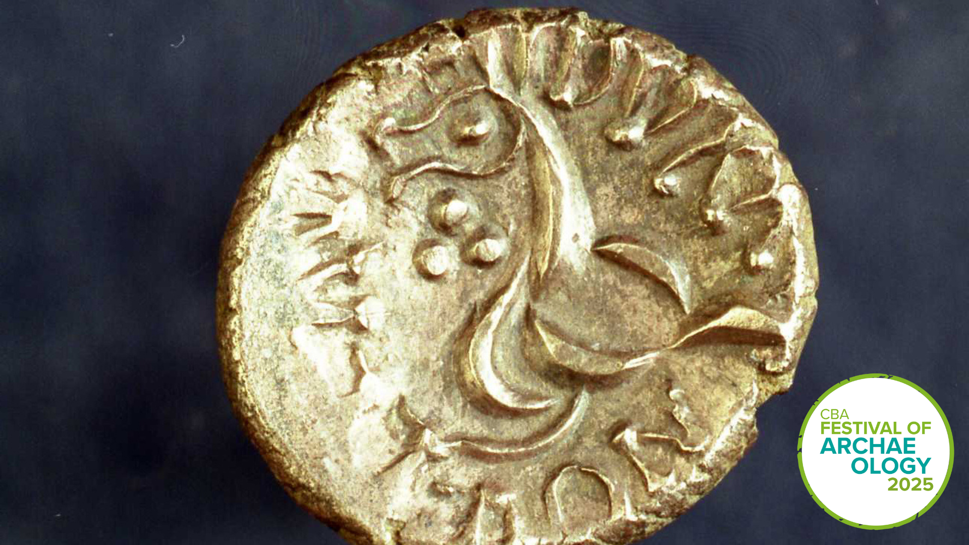 close up of a gold coin with stylised design on it