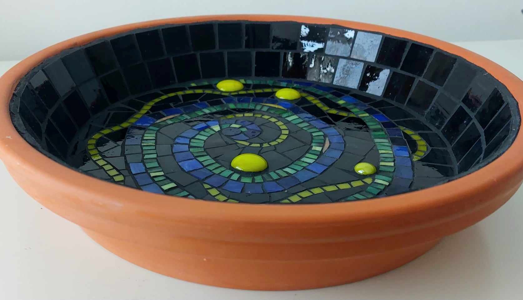 mosiac birdbath on a terracotta base