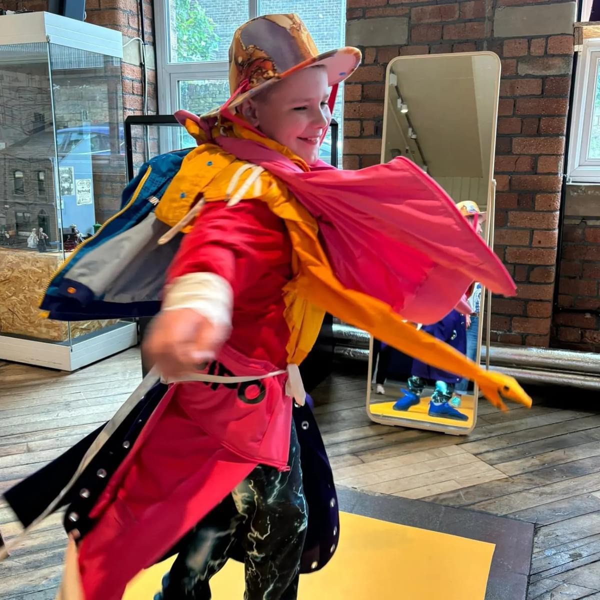 child wearing costume spinning at the end of a catwalk