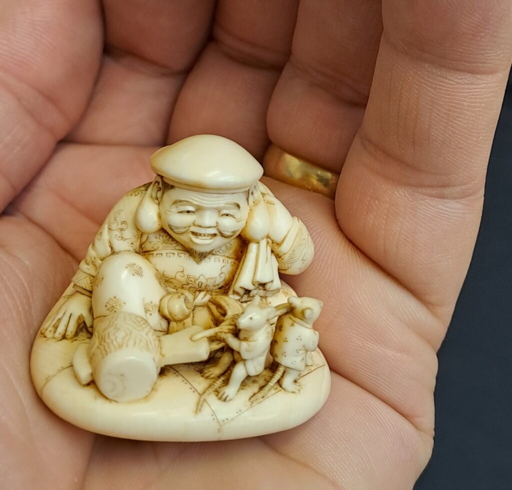 a small carved model of a Japanese deity
