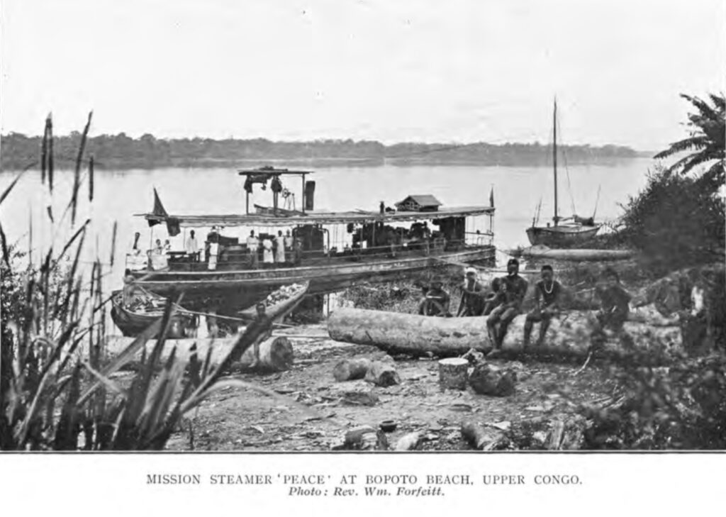 B&W photograph of a boat on the banks of a river, captioned 'Misson Steamer 'Peace' at Bopoto Beach, Upper Congo