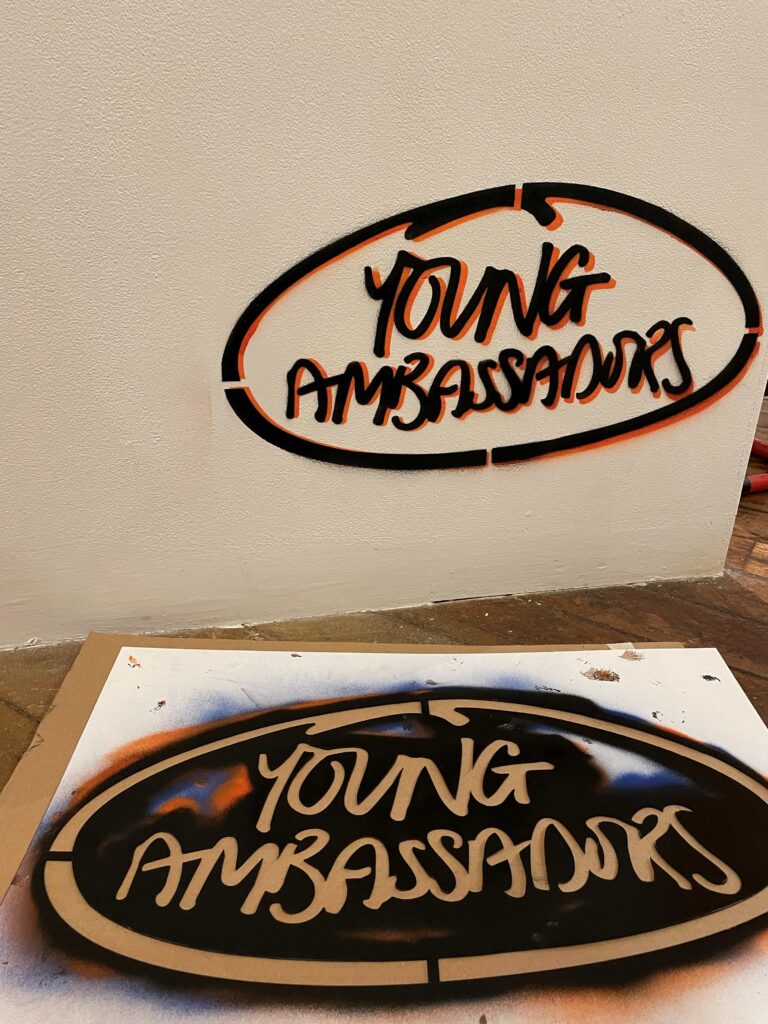 A graffiti style stencil saying 'Young Ambassadors'