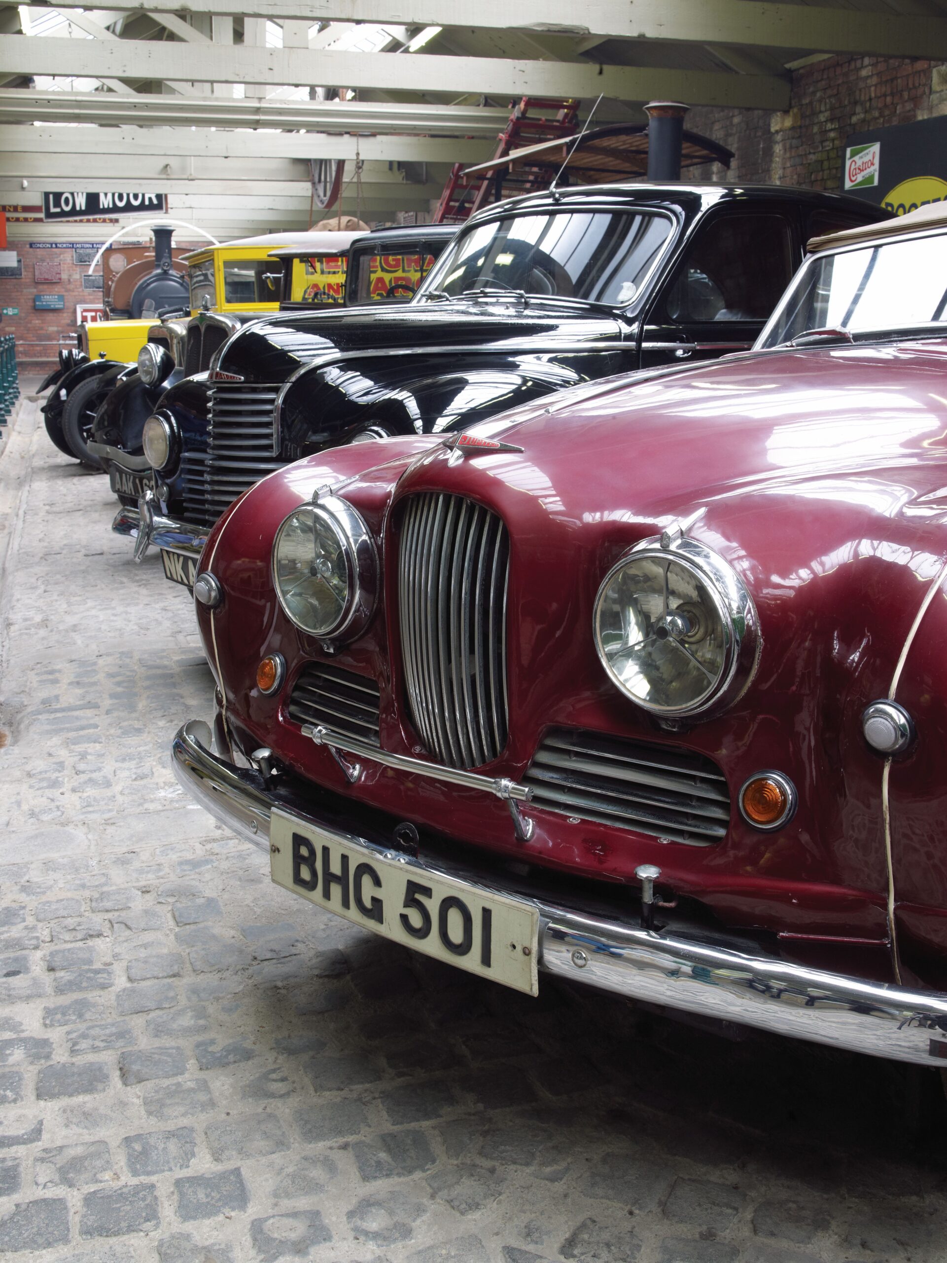 a row of jowett cars inside a gallery space