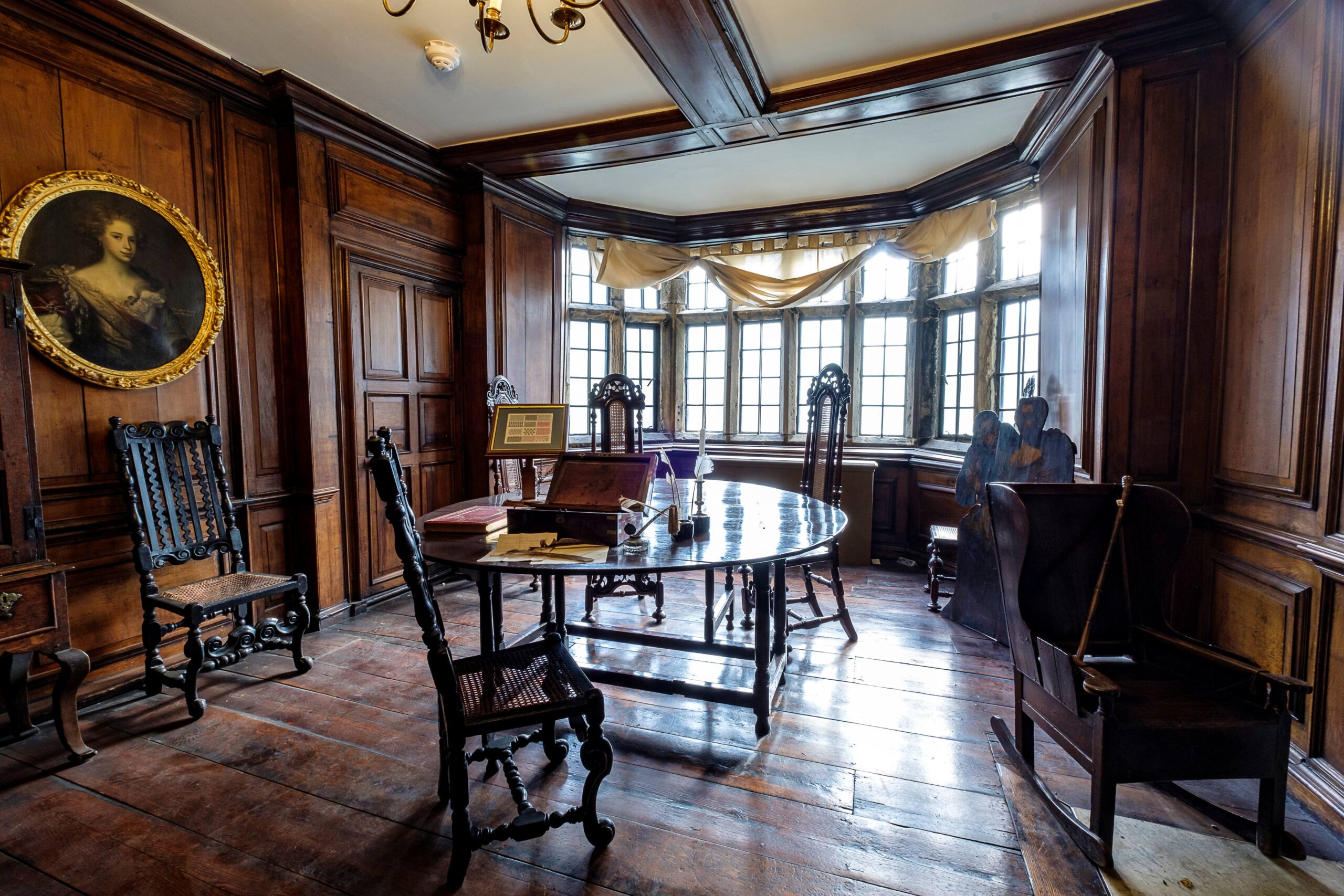 view of an room interior at Bolling Hall with panelled wood walls and a dummy board visible in corner of room