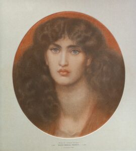 pastel study image of a dark-haired woman -head and shoulders only. She has the strong jaw line, long flowing hair and direct gaze typical of Pre-Raphaelite images.