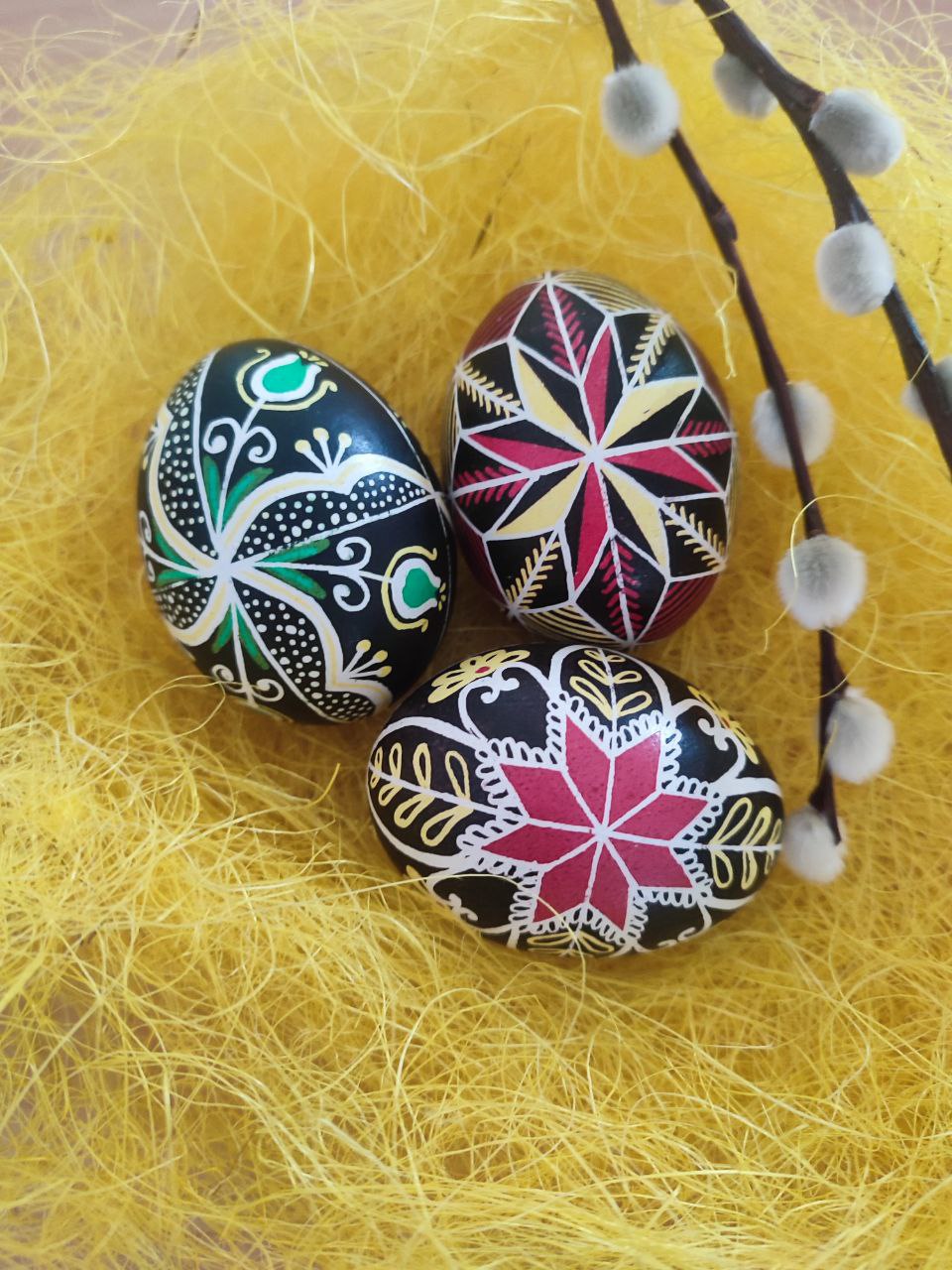 image of painted eggs (pysanky) in a ukranian folk art style - pinks, greens, reds and yellow