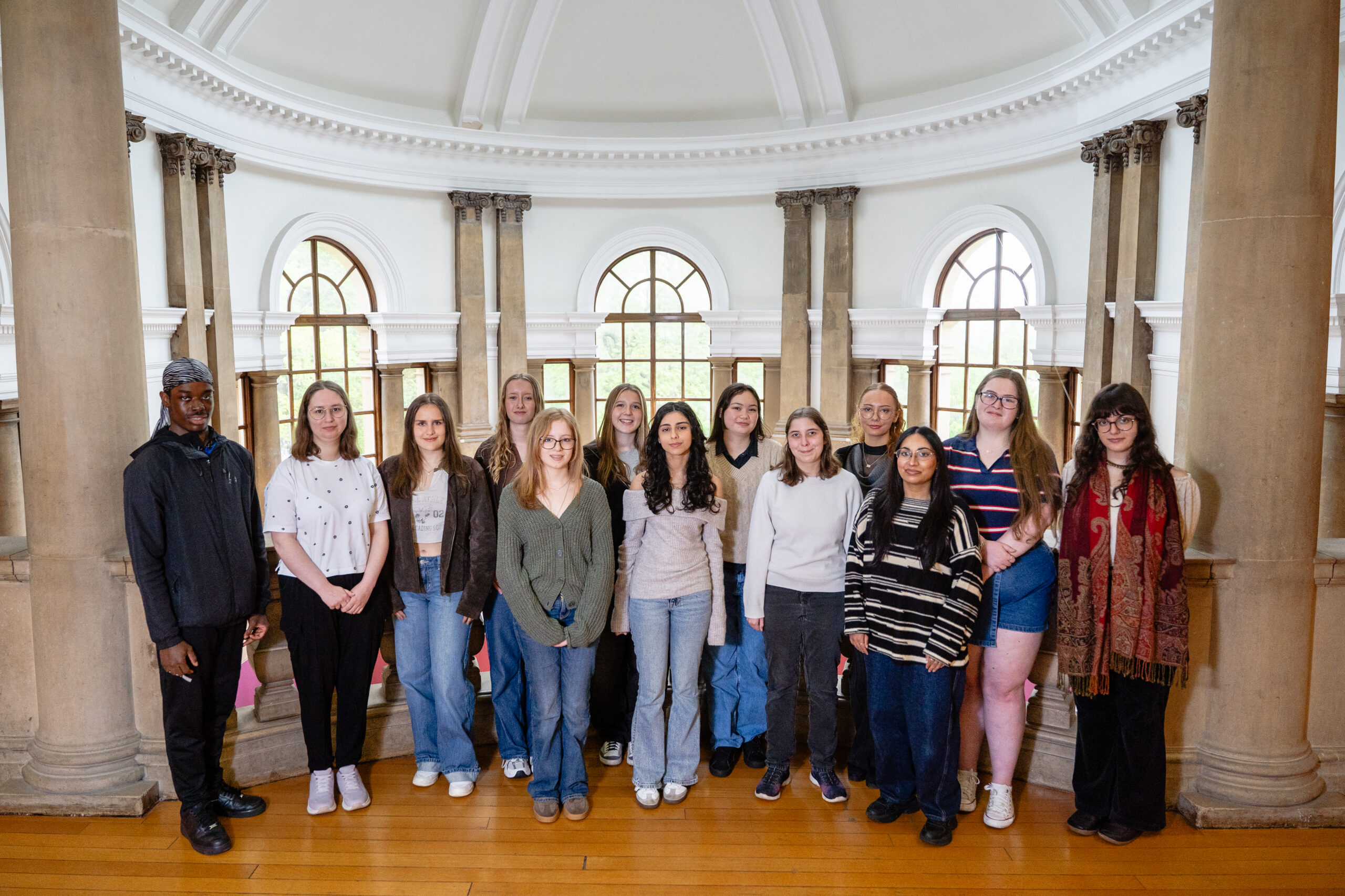 Group of young ambassadors posing indoors.